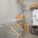 a room with a shelf and clothes on the wall