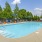 a swimming pool with chairs and umbrellas